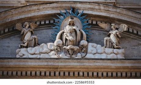the figure of the Virgin Mary on the facade of the church - Shutterstock ID 2258695553