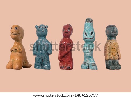 Figures of creatures. Ceramic figures of characters at the display window. DIY pottery. Statues pattern. Child pattern. Collection of colorful ceramic figures. Figures isolated on pastel background