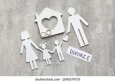 Figures of family, house and paper with word DIVORCE on grunge background