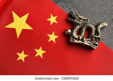 Figurine Of Dragon And Chinese Flag On Dark Background