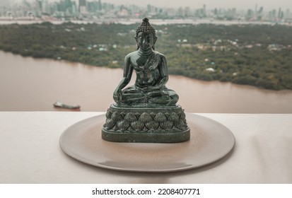 Figurine of Emerald lord buddha gautama or Siddhattha gotama buddha sculpture statue with nature background. Space for text, Selective focus.