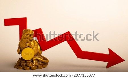 A figurine of a mouse with a gold coin and chart. Concept of unstable currency exchange rates and precious metals price