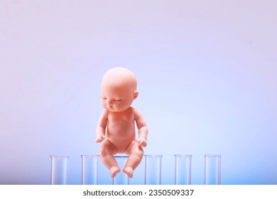 Figurine of a pupa on chemical test tubes. Concept of artificial insemination, test tube baby. - Powered by Shutterstock