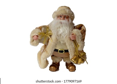 Figurine of Santa Claus in golden clothes holds a bell and a bag with gifts, on a white background isolate