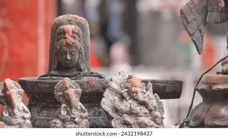 figurine of a shivling and god ganesh