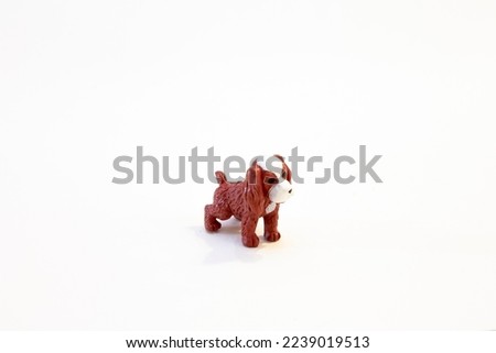 figurine small toy red yellow brown dog on white background isolated object.