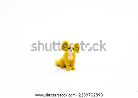 figurine small toy red yellow brown dog on white background isolated object.