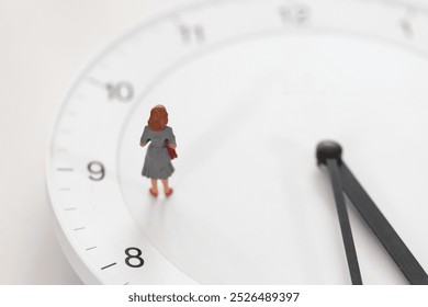 Figurine of woman standing on the white clock. 
Image of working hours, career, employment, deadline, and appointment. - Powered by Shutterstock