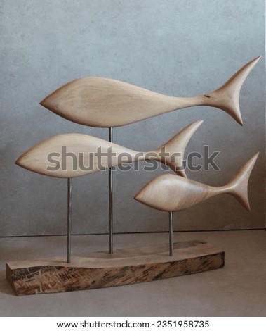 Figurines of fish made of wood in the style of minimalism. For interior design. High quality photo