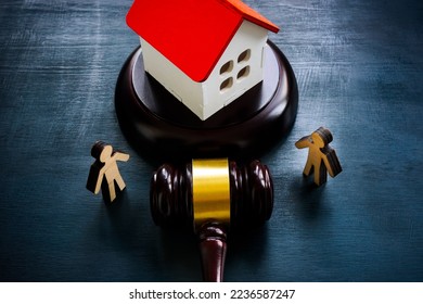 Figurines, model of a house and a gavel, as a concept of inheritance law.