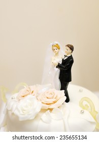 Figurines On Top Of Wedding Cake 