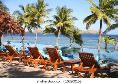 Fiji With Palm Trees, Sea, Pool And Deck Chairs