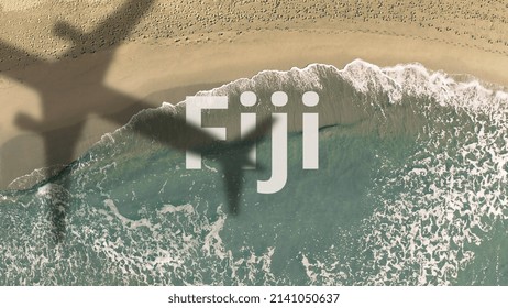 Fiji Text Revealed With The Shadow Of A Flying Commercial Plane On The Beach, Aerial Top-down View