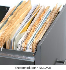 A File Cabinet Drawer Full Of Files And Folders