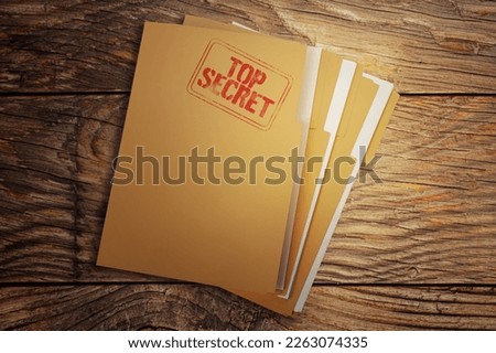 File with documents and Top Secret stamp on wooden table, top view