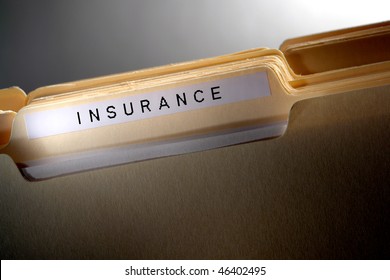 File Folder For Casualty And Risk Coverage Policy Papers In A Stack Of Household Documents With Insurance Title Tab