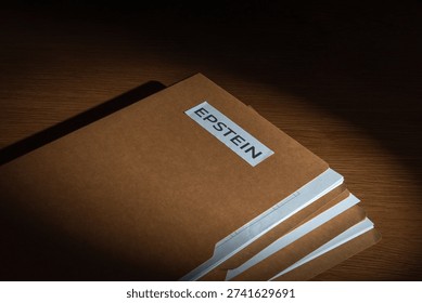A file folder labeled EPSTEIN on a dark surface. Investigations, court documents, hidden evidence, and public scandals related to high-profile legal cases concept.