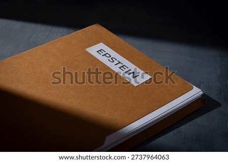 A file folder labeled EPSTEIN on a dark surface. Investigations, court documents, hidden evidence, and public scandals related to high-profile legal cases concept.