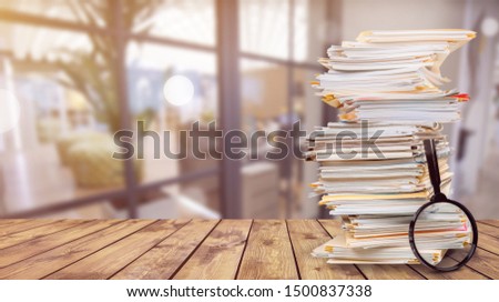 File folders with documents and magnifying glass on background