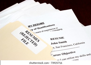 File With Stack Of Rejected Resumes