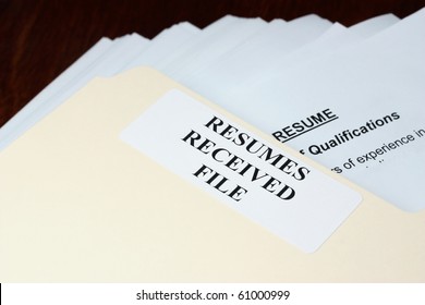 File With Stack Of Resumes Received