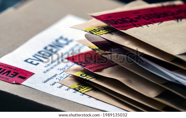 Files\
and evidence bag in a crime lab, conceptual\
image