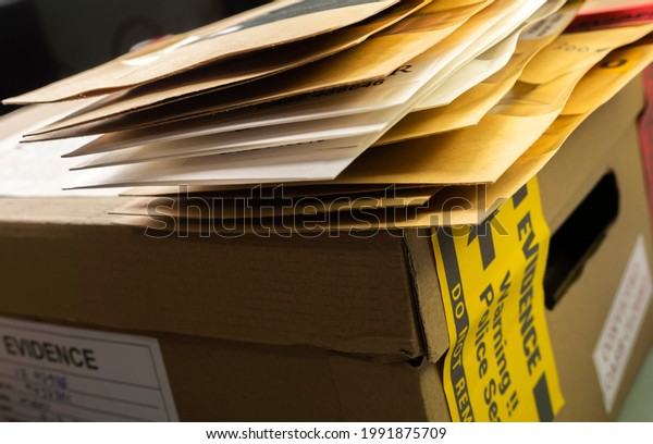 Files\
and evidence bag in a crime lab, conceptual\
image
