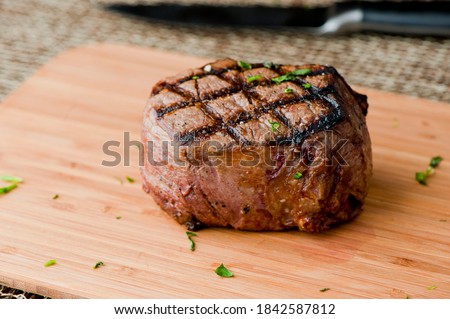 Filet mignon. Grade A grass fed angus beef steak. Tenderloin, filet mignon, New York strip, bone in rib-eye grilled medium rare on outdoor grill. Classic American steakhouse entree favorite.