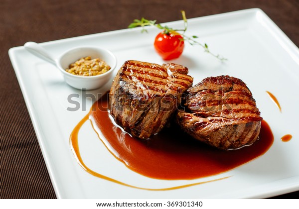 Filet\
mignon with red wine sauce, mustard and\
cherry