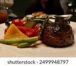 Filet Mignon steak with vegetables close up.