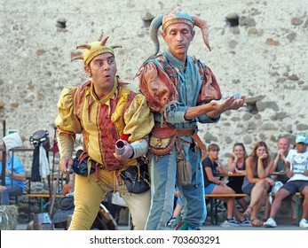 FILETTO, ITALY - AUGUST 15,2017: The annual Medieval market has assorted characters and street artists in a genuinely medieval village, Lunigiana, N Tuscany. Here jesters entertain with crystal balls.