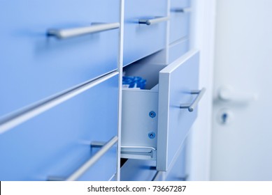 Filing cabinet with an open drawer - Powered by Shutterstock