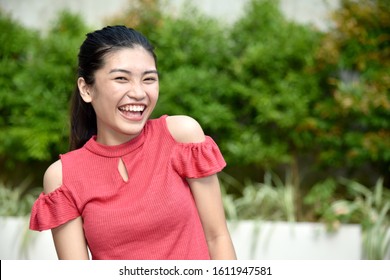 A Filipina Female Laughing Outside - Shutterstock ID 1611947581