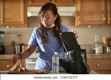 Filipina Nurse In Home Kitchen Packing Lunch For Work