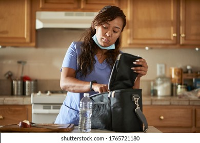 Filipina Nurse In Home Kitchen Packing Lunch For Work