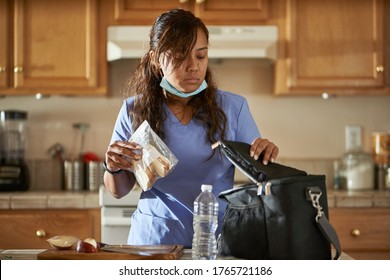 Filipina Nurse In Home Kitchen Packing Lunch For Work