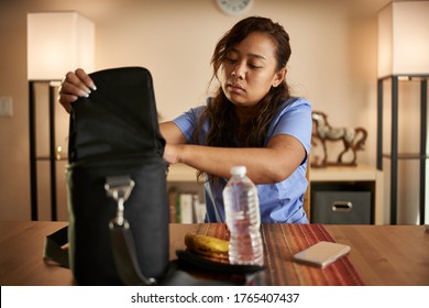 Filipina Nurse At Home Packing Lunch For Work