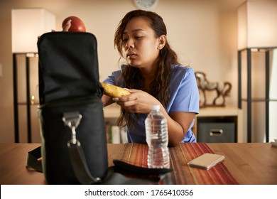 Filipina Nurse At Home Packing Lunch For Work