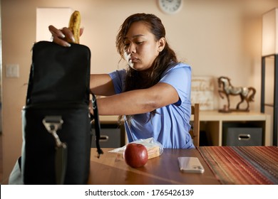 Filipina Nurse At Home Packing Lunch For Work