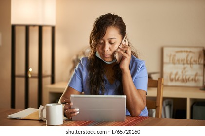 Filipina Nurse Working From Home Talking On Phone