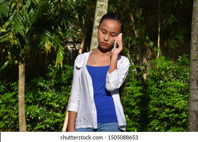 Filipina Teenager Girl Using Cell Phone And Unhappy