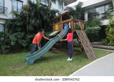 A Filipino Family Playing At A Park Outdoors.