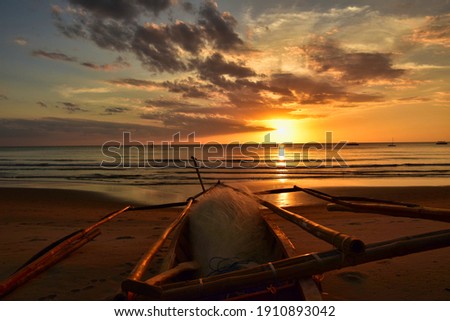 Filipino fishing boat at sunset on the sugar beach, Fishing boat on the beautiful sandy coast of the negros island