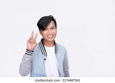 A Filipino Guy Makes A Peace Sign. Isolated On White Background.