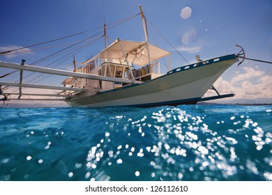 Filipino Outrigger With Diving Tanks Waiting For Divers To Come Aboard And Ready To Navigate