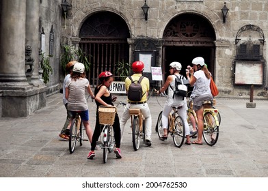Filipino people guide and foreign travelers travel visit San Agustin Church and use bicycle biking on street tour around intramuros square at Maynila city metro on April 17, 2015 in Manila, Philippine