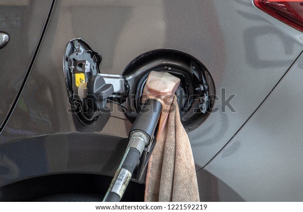 To fill the car with fuel, close up. Car\
refueling on a petrol station. Gasoline at a gas station pump. Fuel\
pump with gasoline.