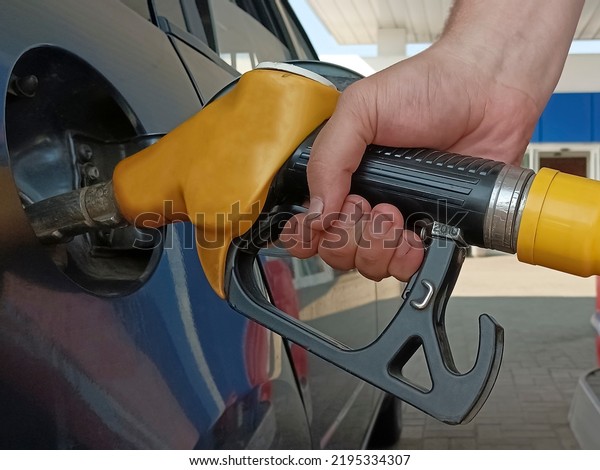 fill the\
car with fuel. a man at a gas station is self charging a car. male\
Refueling A Car At The Gas Station. no face. unrecognizable person.\
refill. refueling for motor\
transport