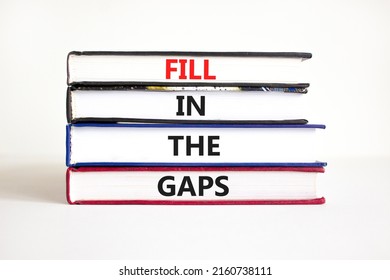 Fill in the gaps symbol. Concept words Fill in the gaps on books on a beautiful white table white background. Business, motivational and fill in the gaps concept.