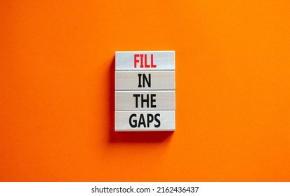 Fill in the gaps symbol. Concept words Fill in the gaps on wooden blocks on a beautiful orange table orange background. Business, motivational and fill in the gaps concept.